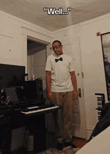 a man wearing glasses and a bow tie is standing in front of a keyboard with the words " well " written above him
