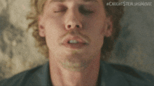 a close up of a man 's face with the hashtag #caughtsstealingmovie on the bottom