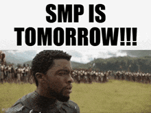 a man is standing in front of a field with the words smp is tomorrow