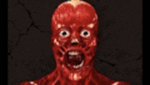 a close up of a red monster 's face with a screaming mouth .