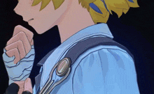 a close up of a person wearing a blue shirt with a strap around their neck