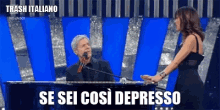 a man is singing into a microphone while a woman stands next to him and says trash italiano