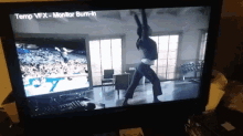 a tv screen shows a woman doing yoga and the words temp vfx-monitor burn-in on the bottom