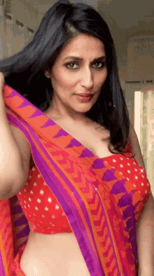 a woman in a red top and purple and orange saree