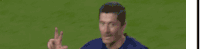 a blurry picture of a soccer player waving his hand in the air .