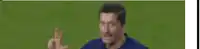a blurry picture of a soccer player waving his hand in the air .