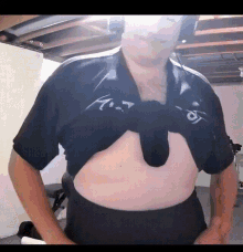 a man is wearing a black shirt that says a.t.