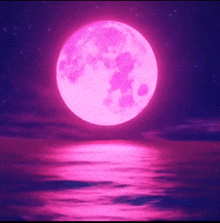 a full pink moon is reflected in the water at night