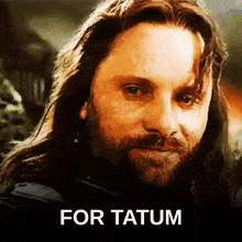 a close up of a man with long hair and a beard with the words for tatum on the bottom