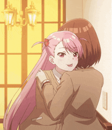 a girl with pink hair hugging another girl with brown hair