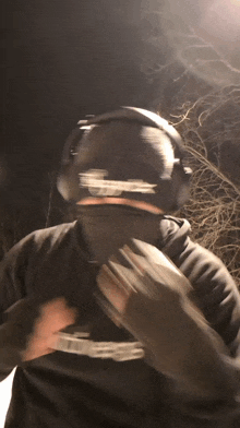 a man wearing headphones and a hoodie with the word supreme on it