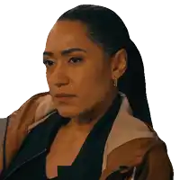 a woman with a ponytail is wearing a jacket and earrings