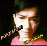a man wearing ear buds and a pink shirt with the words pokemon silahkan on his face