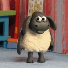 a cartoon sheep with big eyes is standing on a blue carpet in a room .