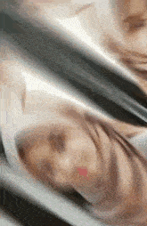 a woman wearing a hijab is taking a selfie with a camera .