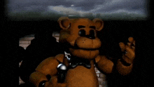 a brown teddy bear is standing in a dark room holding a flashlight .
