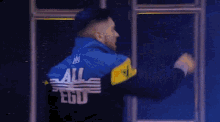 a wrestler is walking through a tunnel with a sign that says sky