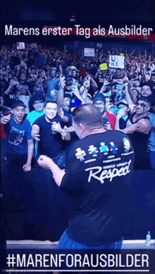 a man wearing a shirt that says respect is standing in front of a crowd of people
