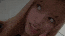 a woman with a nose ring is looking at the camera .