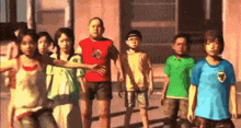 a group of children are standing next to each other in a row .