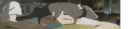 a girl with pigtails is laying on a table with her head on a cell phone .