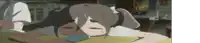 a girl with pigtails is laying on a table with her head on a cell phone .