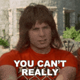 a man wearing a red shirt says " you can 't really "