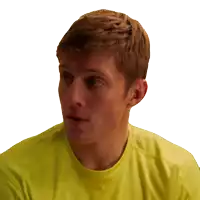 a close up of a man 's face in a yellow shirt