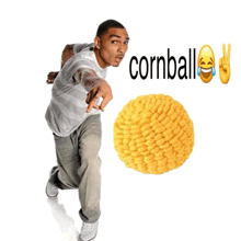a man is pointing at a cornball with a peace sign behind him
