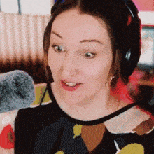 a woman wearing headphones and a microphone on her neck