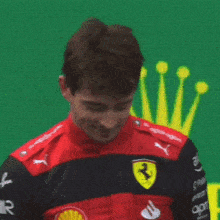 a man wearing a red and black jacket with ferrari on it