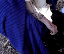 a person with a tattoo on their arm that says ' world the good ' on it