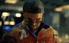 a man wearing sunglasses and a jacket that says barbasol