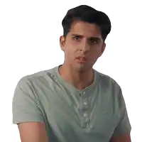 a man wearing a green shirt with buttons on the front looks surprised