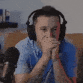 a man wearing headphones is sitting on a couch .
