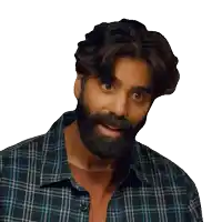 a man with a beard and plaid shirt looks at the camera