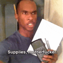 a man is holding a calculator and a piece of paper and saying `` supplies motherfucker '' .