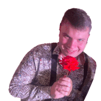 a man in a paisley shirt and suspenders is holding a red rose