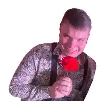 a man in a paisley shirt and suspenders is holding a red rose
