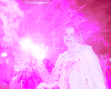 a woman in a white jacket is surrounded by a pink light