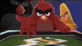 two angry birds are playing a game on a table with a red bird .
