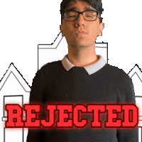 a man wearing glasses and a black sweater has the word rejected in red letters behind him