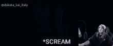 a woman wearing headphones is screaming in front of a microphone