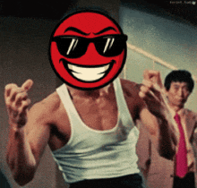 a man in a white tank top with a red smiley face on his face