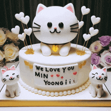 a white cake that says we love you min yoongii