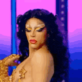 a drag queen is standing on a stage wearing a leopard print costume .