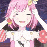 a girl with pink hair is smiling and holding her hands to her face