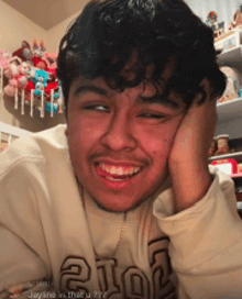 a young man wearing a hoodie that says 2102