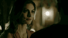 a woman in a red dress is looking at a man