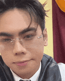 a close up of a man wearing glasses and a leather vest